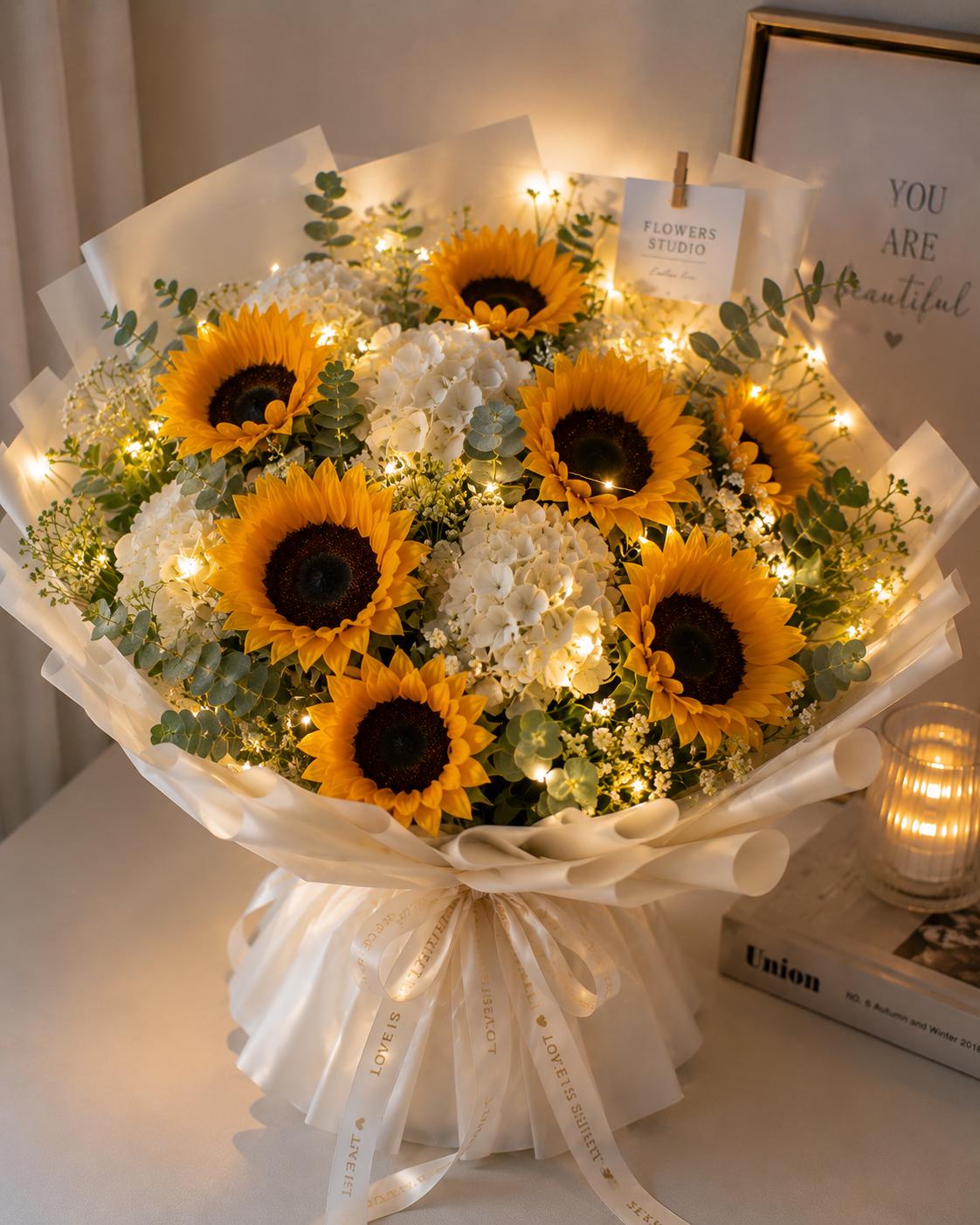A bouquet of seven sunflowers and hydrangeas with a glowing ribbon