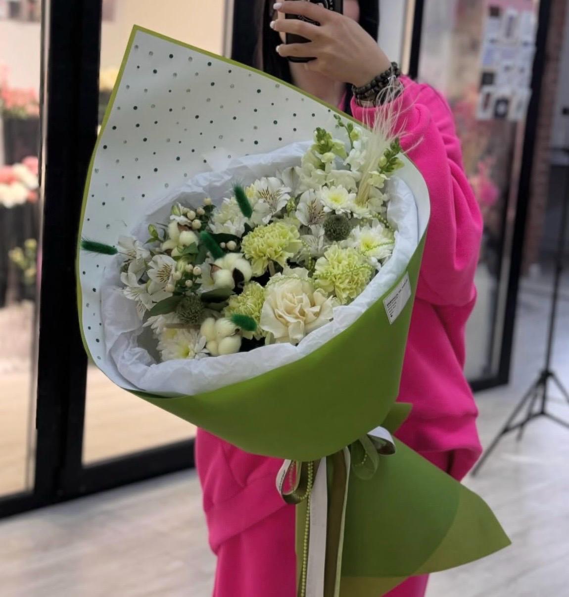 An arrangement in green tones featuring green carnations, green hydrangeas, and white chrysanthemums